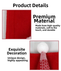 Detail of red felt and knit Christmas handle cover with soft white plush pom-poms