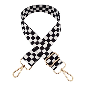 Adjustable black and white checkerboard patterned fabric bag strap with gold metal buckles