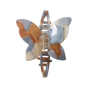 French butterfly acetate claw clip with blue and orange marble pattern for elegant updos
