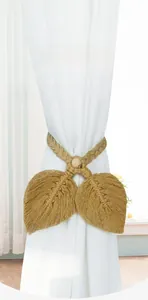 Detailed view of hand-woven cotton leaf curtain tieback with a round wooden bead