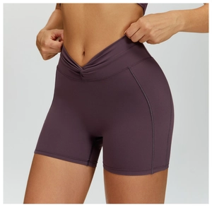 Dettaglio degli shorts da yoga a vita alta incrociata a V in tessuto tecnico prugna