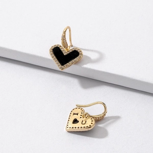 Detail of gold heart earrings with zircon inlay and I Love You engraving on back