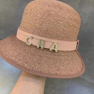 Pink straw sun hat with leather strap and sparkling rhinestone letter decorations