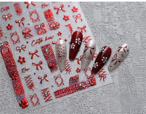 Macro detail of red velvet bow nail stickers with metallic stars and ribbon patterns