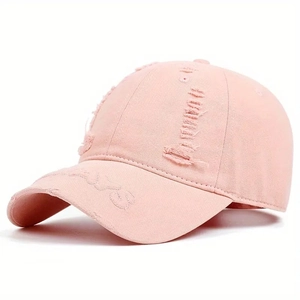 Detailed view of the light pink distressed twill cotton baseball cap with torn fabric edges