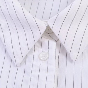 Macro detail of classic striped shirt collar with white buttons and precise stitching