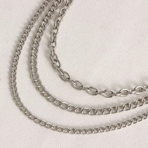 Close-up of triple-layered silver metal waist chain with hollow heart charms