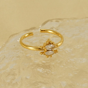 Detailed macro view of golden adjustable ring with marquise-cut marquise-cut zircons
