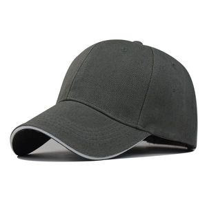 Detail view of dark grey baseball cap showing cotton twill fabric and white sandwich brim