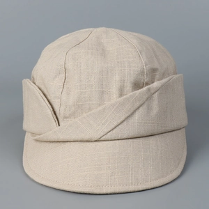 Detailed close-up of light beige cotton linen newsboy hat showing woven texture