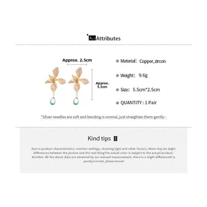 Detail view of 18k gold plated flower drop earrings with zircon inlay and product size specs