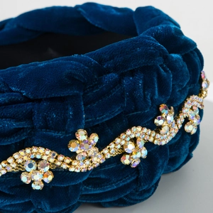 Detail of dark blue velvet braided headband featuring sparkling crystal flower accents