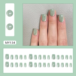 Sage green cat eye press-on nails with 24 short square pieces in a professional set