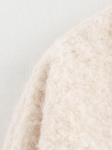 Close-up of soft off-white mohair faux fur texture on a cozy tie-up cardigan sweater