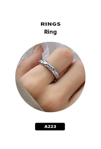 Detail view of silver titanium steel ring featuring an irregular hammered texture on finger