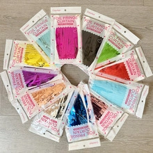 Close-up of colorful foil fringe curtains in clear packaging for party backdrops
