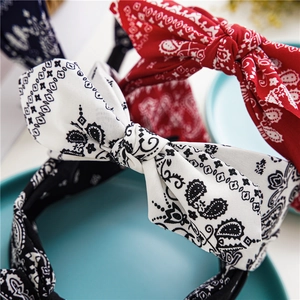 Close-up of paisley pattern knot headbands with large bows in white, red and navy blue