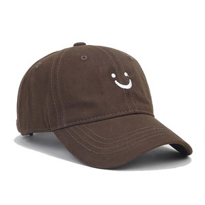 Detailed embroidery of a white smiley face on a premium dark brown cotton baseball cap