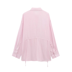 Rear view of pink long-sleeved shirt featuring adjustable drawstring waist and fabric texture