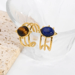 Vintage stainless steel open rings with tiger eye and lapis lazuli on stone decor