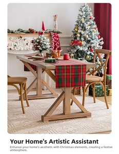 Detail of red and green plaid Christmas table runner with gold thread in a festive setting