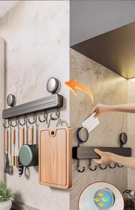 Strong suction cup kitchen hook rack holding heavy pans and cutting board on marble wall