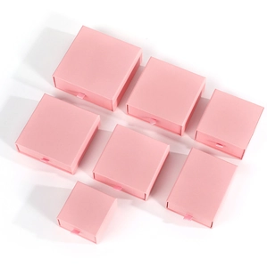Top view of pink drawer-style jewelry gift boxes in various sizes with ribbon pulls