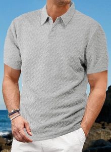 Close-up of men's grey short-sleeve polo shirt showing 3D herringbone texture and collar detail