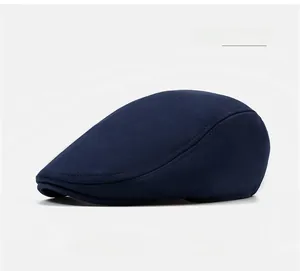 Detailed close-up of navy blue cotton flat cap showing fine stitching and fabric texture