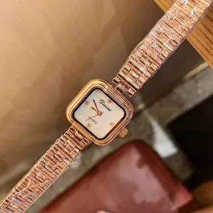 Square rose gold quartz watch for women with a white dial and metallic link bracelet