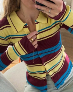 Detail of colorful striped knit polo shirt showing ribbed texture and buttoned collar
