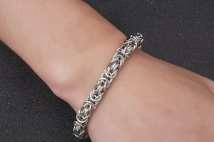 Close-up of a silver Byzantine chain bracelet for men in polished stainless steel