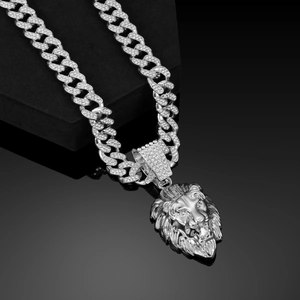 Macro shot of silver lion head pendant on cuban chain with clear reflection and crystal details