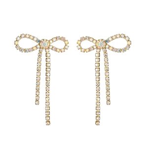 Detailed view of sparkling bow earrings with golden tassels and colorful rhinestones