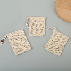 Detailed view of woven cotton mesh soap bags with drawstring and wooden beads