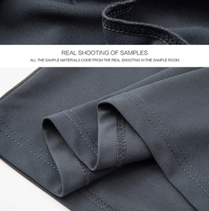 Macro shot of dark grey moisture-wicking mesh fabric with premium stitching details