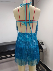 Detail of the back of a blue sequined fringe romper with backless tie design and hidden zipper