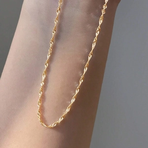 Minimalist creative twisted gold necklace chain displayed on arm for a stylish look