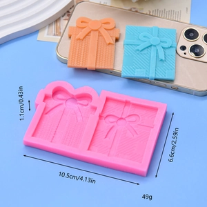 Pink silicone mold featuring two gift box shapes with bows for cake and chocolate baking