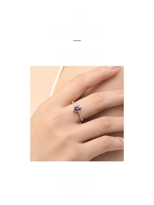 Macro detail of s925 silver ring with oval ruby gemstone and sparkling side diamonds
