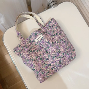 Floral cotton canvas handbag with purple flower pattern and top zipper closure