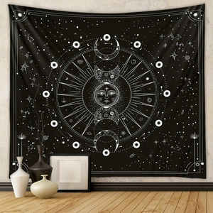 Minimalist black sun and moon wall tapestry hanging on a textured wall in a cozy room