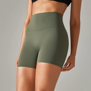 Detail view of high-waist olive green yoga shorts with wide waistband and matte texture