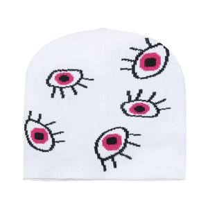 White knit beanie with pink and black eye patterns for winter warmth and style