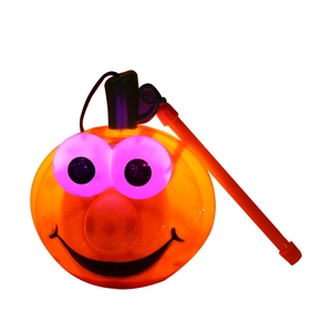 Light-up pumpkin lantern with purple glowing eyes and black handle for Halloween decor