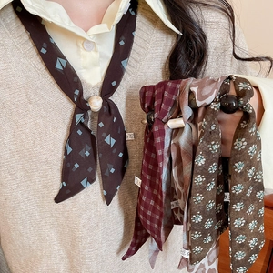 Close-up of chiffon scarf necklace with vintage patterns and elegant buckle detail