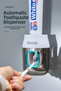 Detail of automatic toothpaste dispenser showing the push-to-squeeze mechanism in action