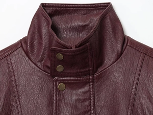 Detail of dark red PU leather jacket featuring stand collar and bronze snap buttons