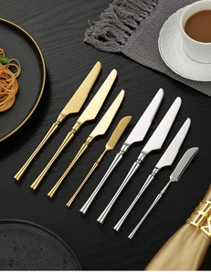 Detailed flat lay of premium 304 stainless steel steak knives in gold and silver finish