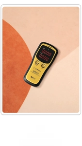 Macro view of handheld air quality monitor measuring HCHO and TVOC on a dual-tone surface